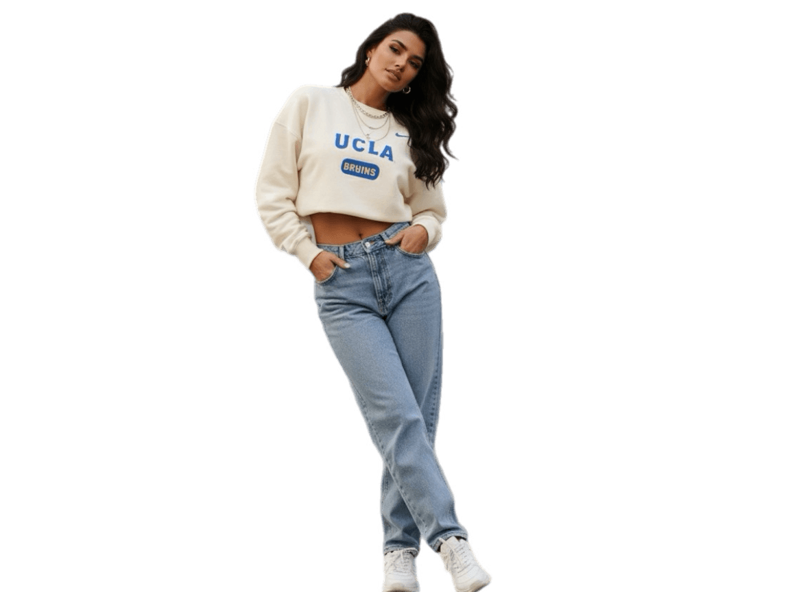 Nike women’s cream cropped sweatshirt with UCLA blue logo, paired with light wash denim jeans, casual streetwear style